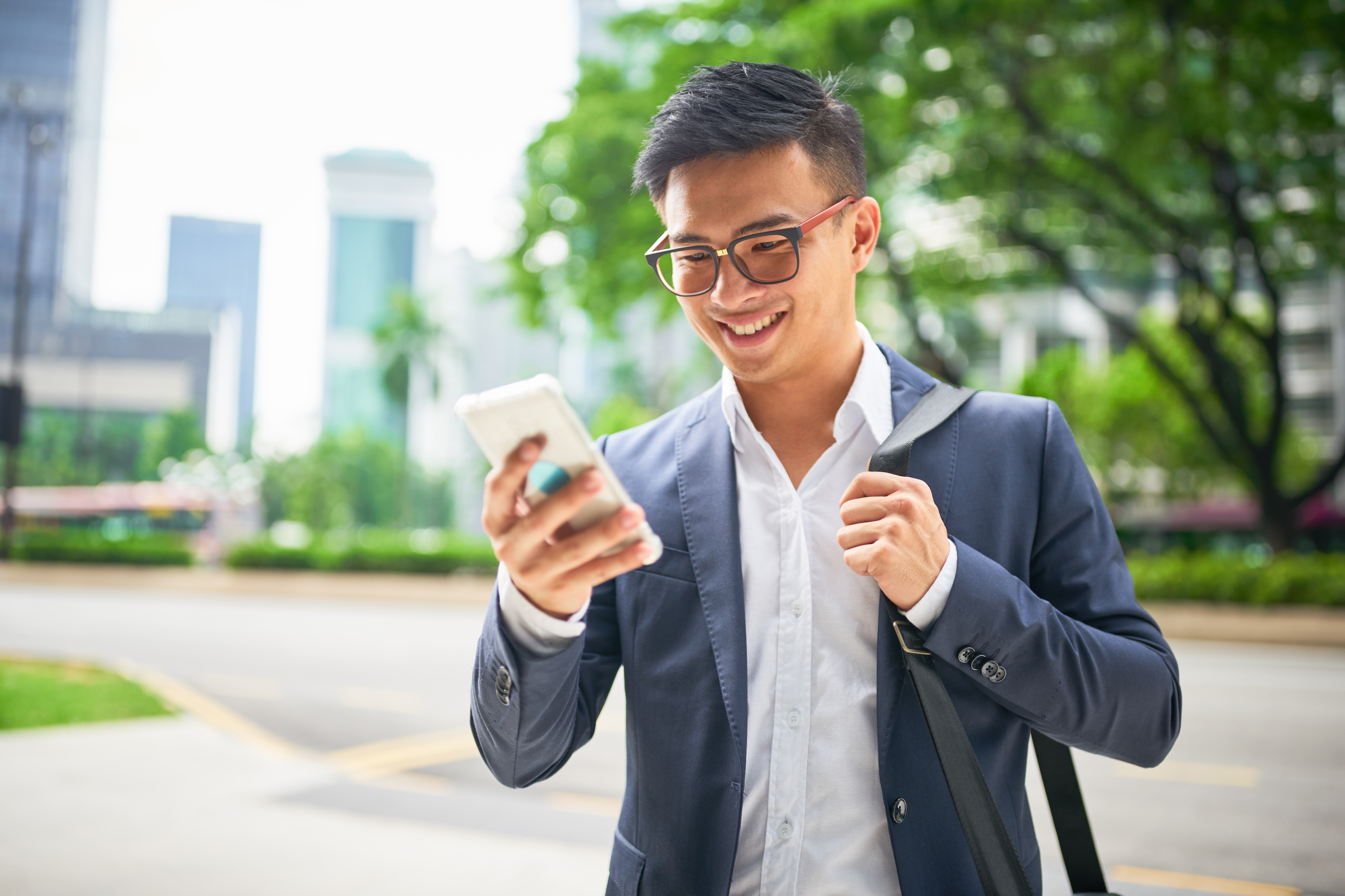 Man on mobile phone walking down street