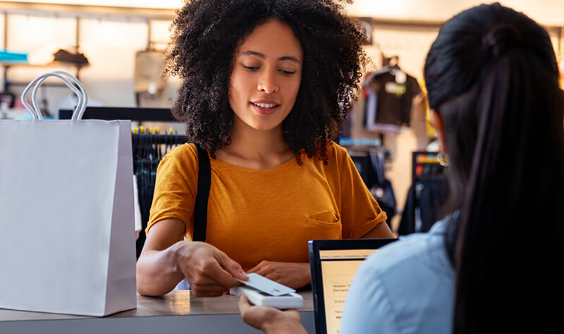 woman paying by card at a clothing store
